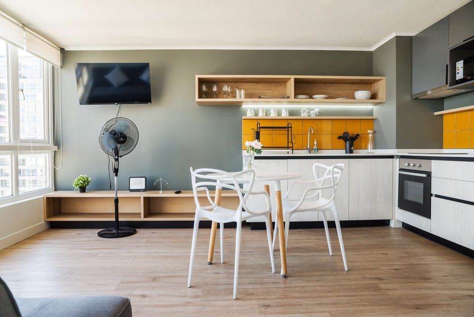 Stylish kitchen with vibrant backsplash and dining area, ideal for cozy meals with a view.