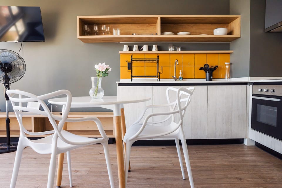 Bright and stylish kitchen with a pop of yellow, perfect for intimate meals and relaxation.