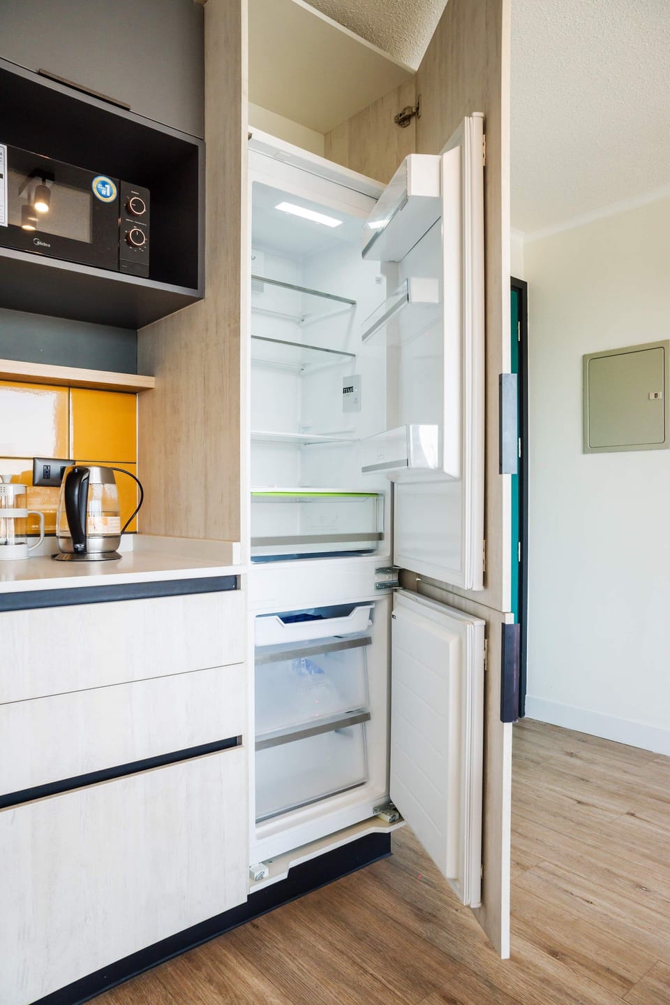 Sleek kitchen with modern appliances and vibrant accents, ideal for culinary creativity.