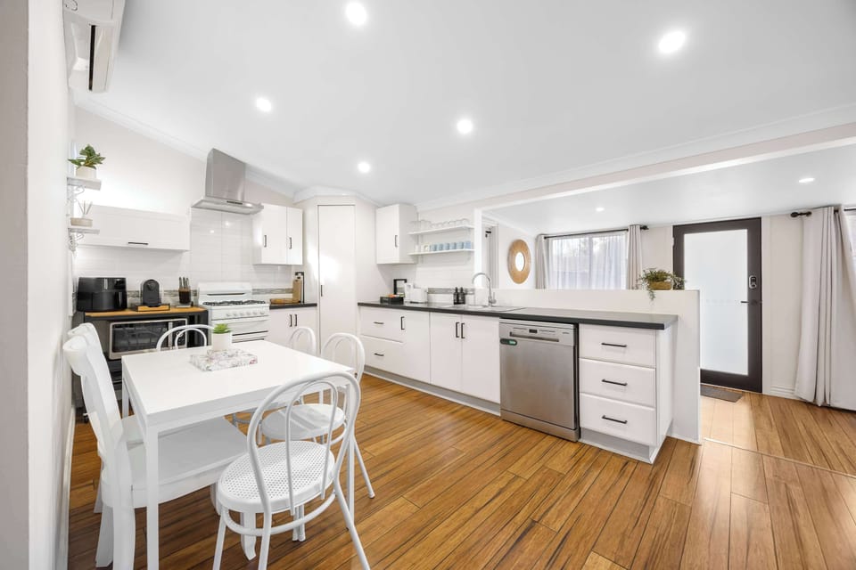 Fully equipped kitchen with gas cook top, oven, dishwasher, microwave and coffee pod machine. 