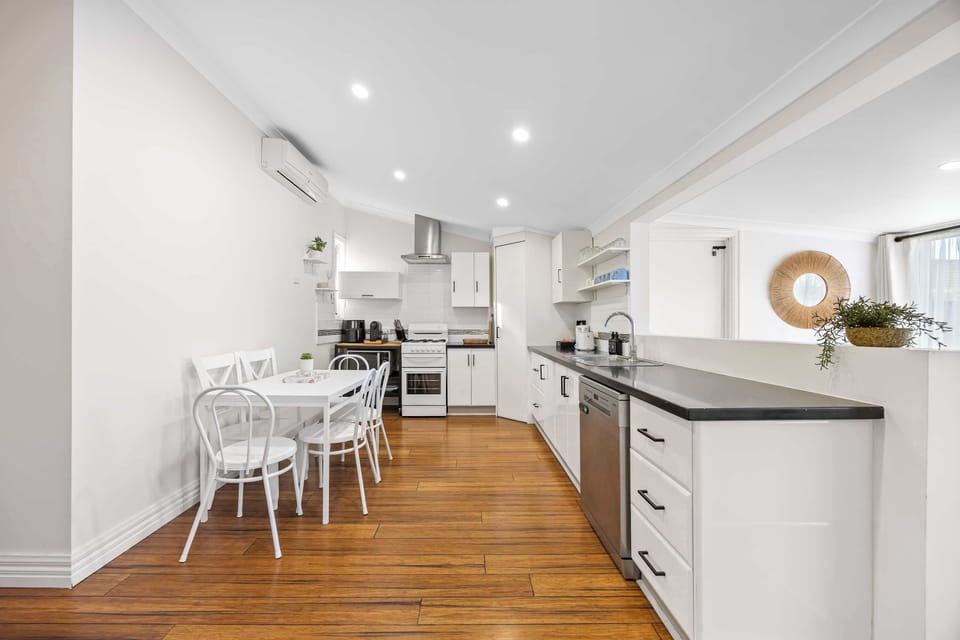 Fully equipped kitchen with gas cook top, oven, dishwasher, microwave, coffee pod machine and ample seating for all guests.