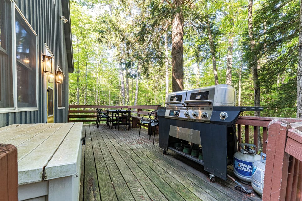 Deck view, including grill, outdoor dining area, and front entrance.