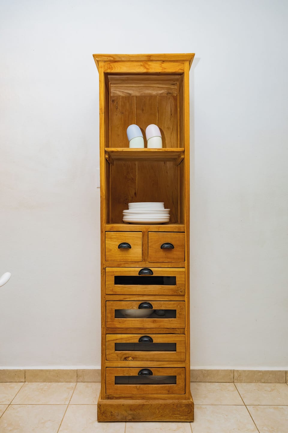 Wooden cabinet with neatly arranged kitchenware