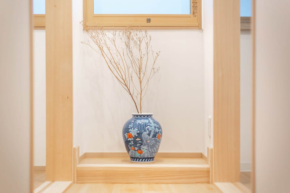 A peaceful visual break in the hallway featuring elegant floral ceramic artwork