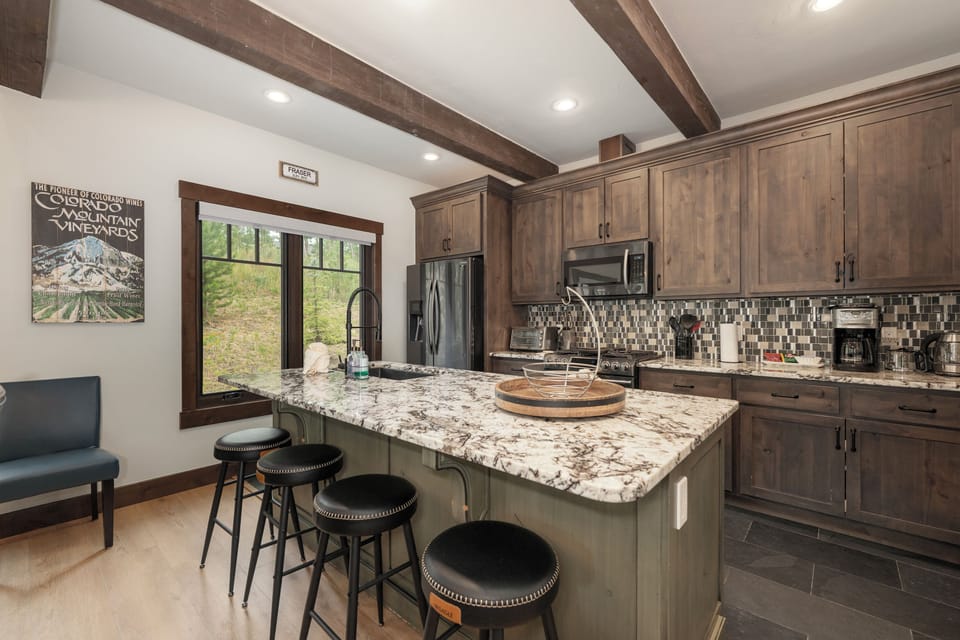 Your gourmet kitchen features granite counters, rustic wood beams, and modern appliances perfect for creating memorable meals together.