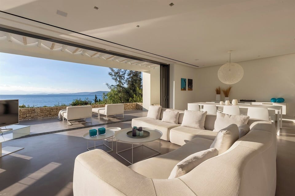 The living and dining area with its fully retractable sliding glass walls.