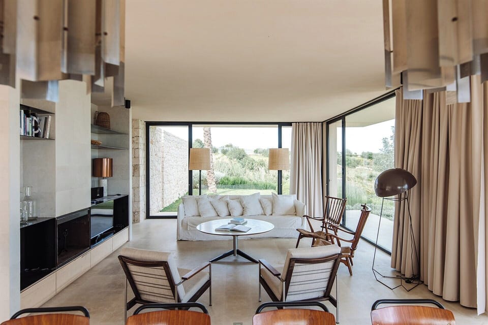 The luminous living area, with its floor-to-ceiling, wall-to-wall glass.