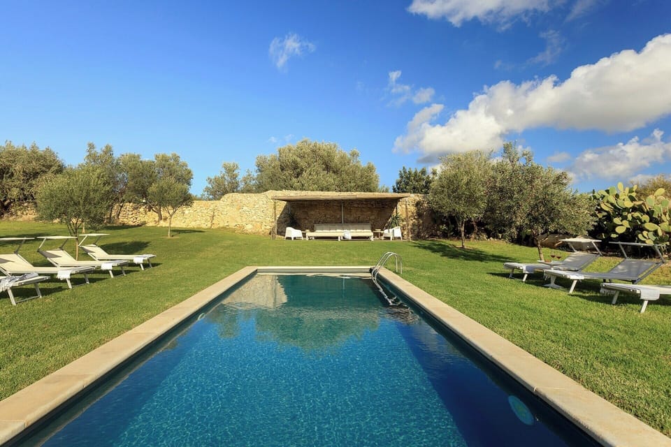 The cobalt blue pool surrounded by emerald green lawns.