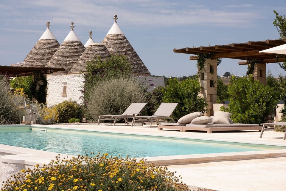 Four of OttoConi's eight trulli cones rising above the pool.