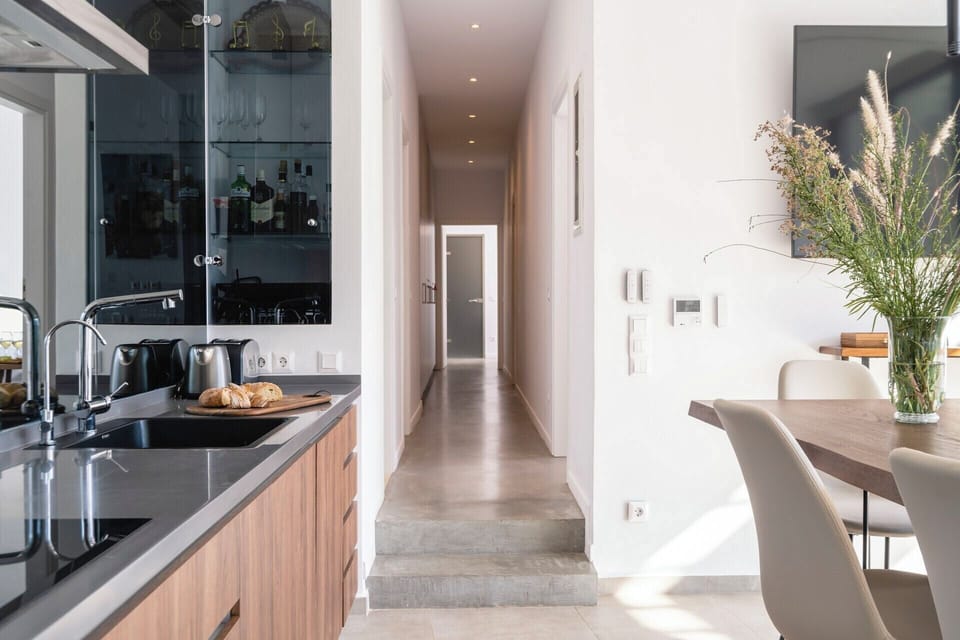 A corridor links the communal space to the bedrooms.