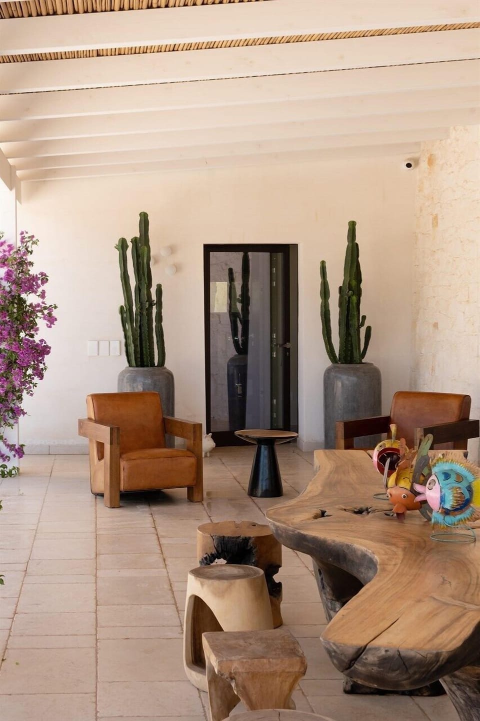 The shaded al fresco living and dining area outside the main entrance.