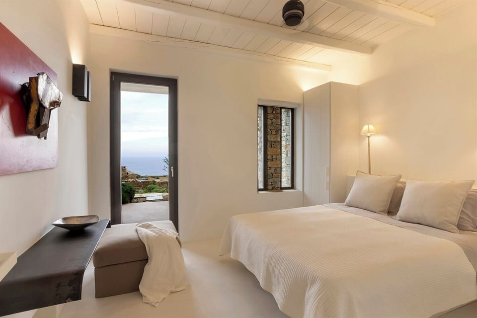 The second double bedroom in the guesthouse, with its sea views and terrace access.