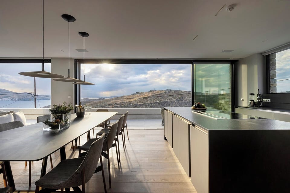 The panoramic open-concept living and dining area in the main house.