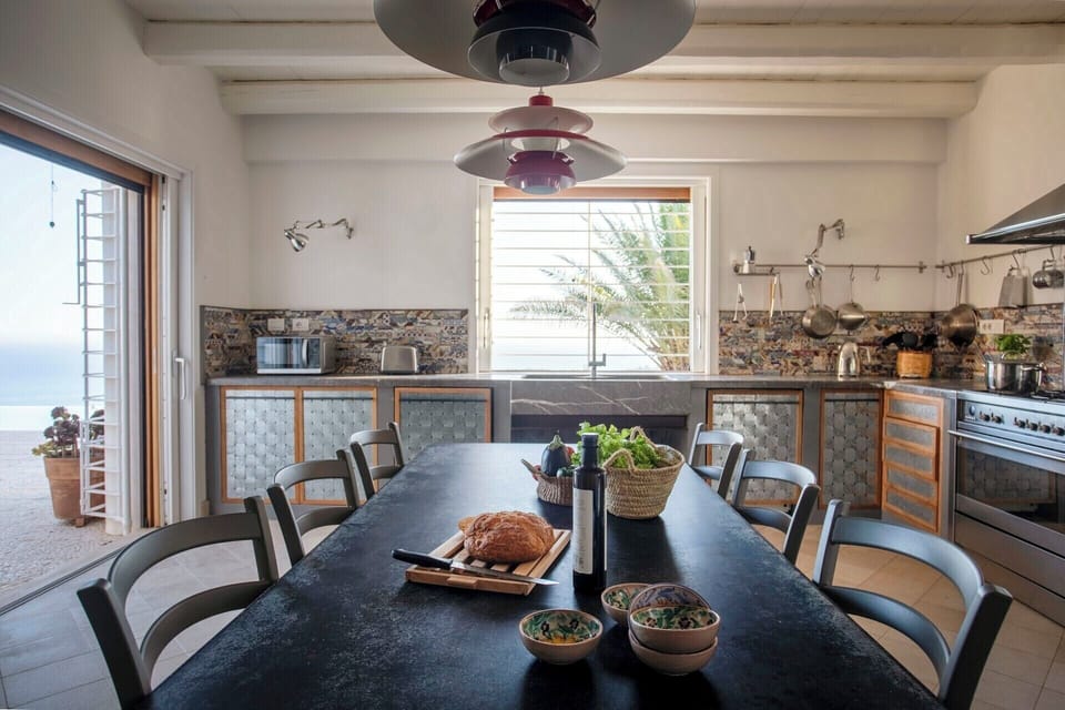 The kitchen has views over the sea and access to the front terrace.
