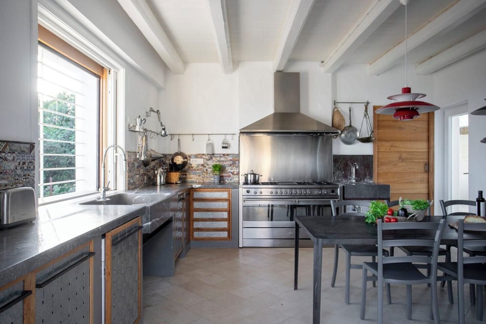The very well equipped kitchen and indoor dining room.