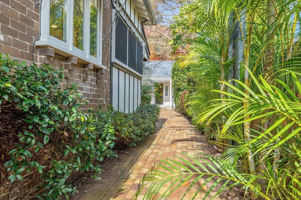 Access is via the side gate, with a leafy path leading straight to the studio at the rear of the property.