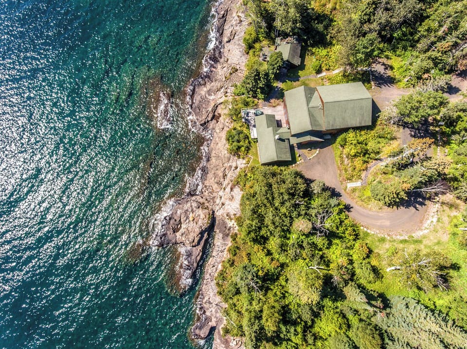 The two homes share 300 feet of ledge rock Lake Superior shoreline.