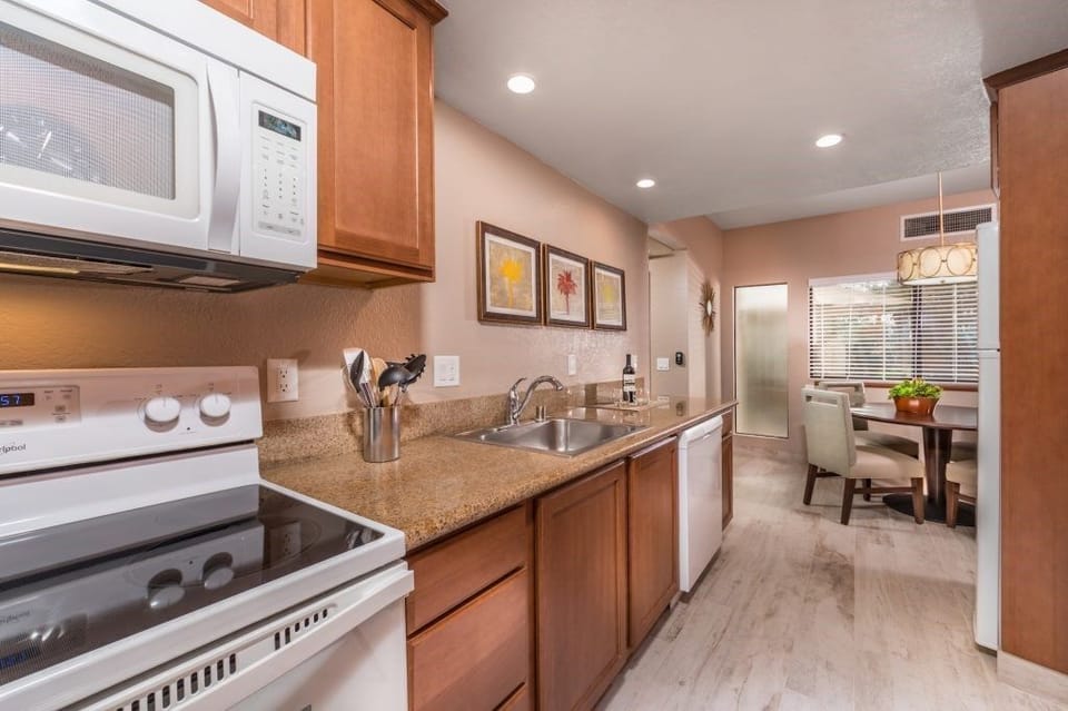 This fully-equipped kitchen boasts sleek appliances and ample counter space, perfect for culinary adventures while enjoying casual dining nearby.