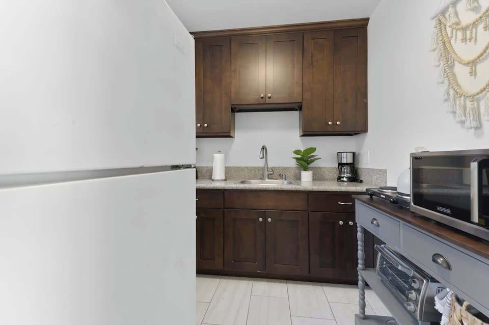 Cozy and functional kitchen with rich wooden cabinets and modern appliances.