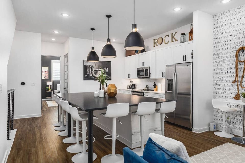 Massive kitchen island with seating for 10. High-end appliances including a wine cooler for a luxe cooking experience.