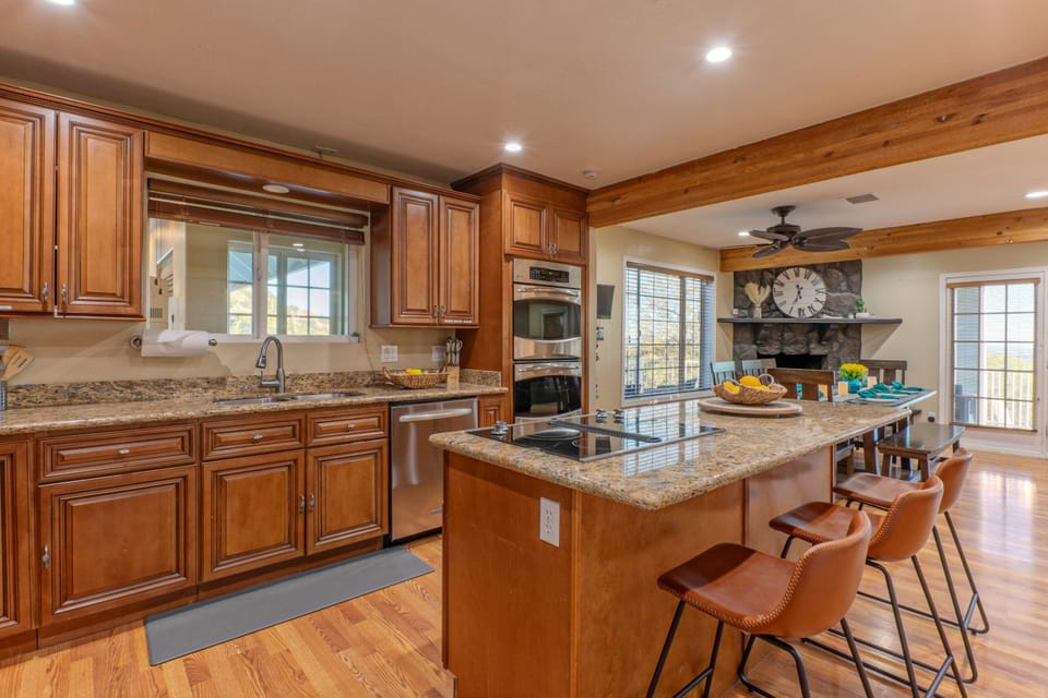 Kitchen in our main home opens into dining area with views.