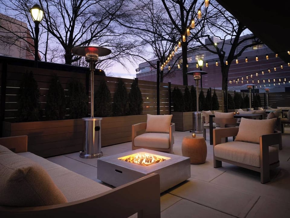 Unwind by the glowing fire pit under twinkling lights.