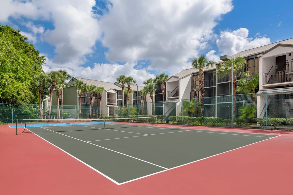 Play a match on the sunny courts beside palm-lined views.