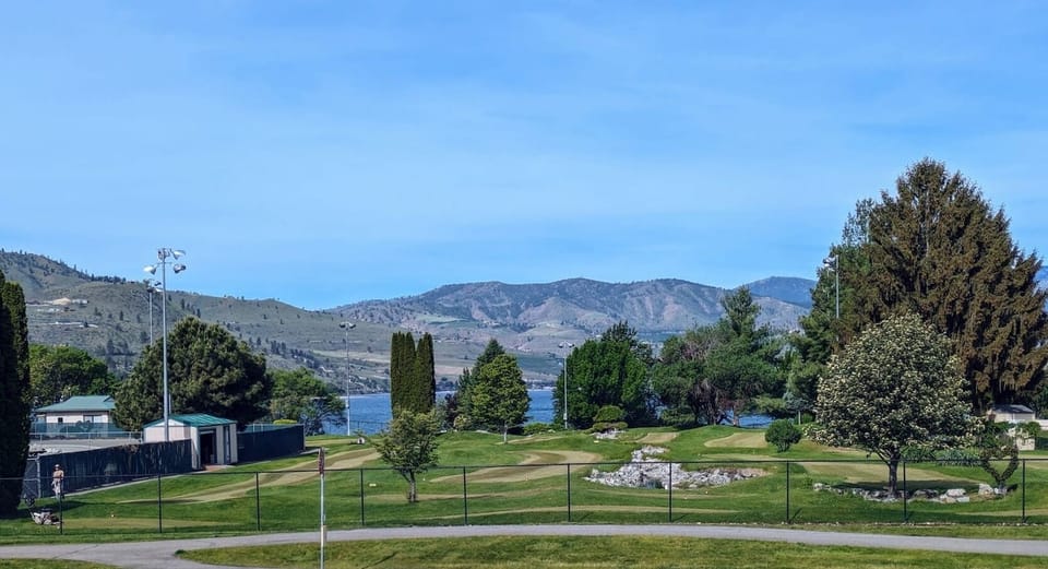 Pass the time kicking back and watching the mini golf players.
