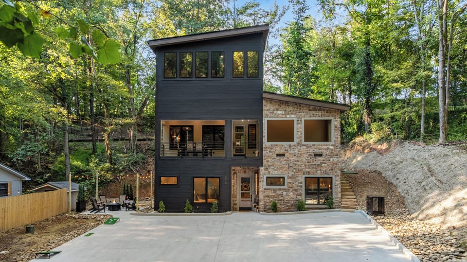 Stunning modern cabin exterior surrounded by peaceful forest views.