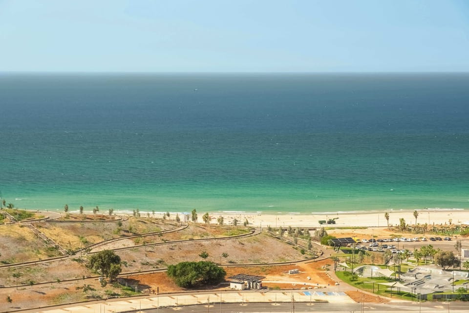 Endless turquoise horizon meets sandy shoreline, placing you steps from vibrant cafes and seaside strolls.