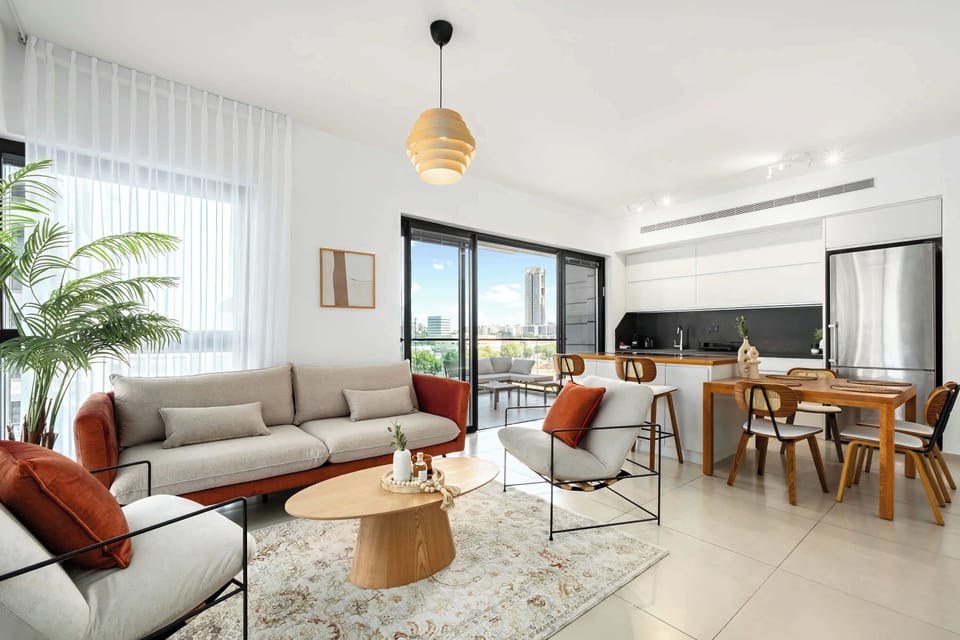 Open-plan layout keeps everyone connected, from relaxed sofa time to shared dinners and balcony breezes.