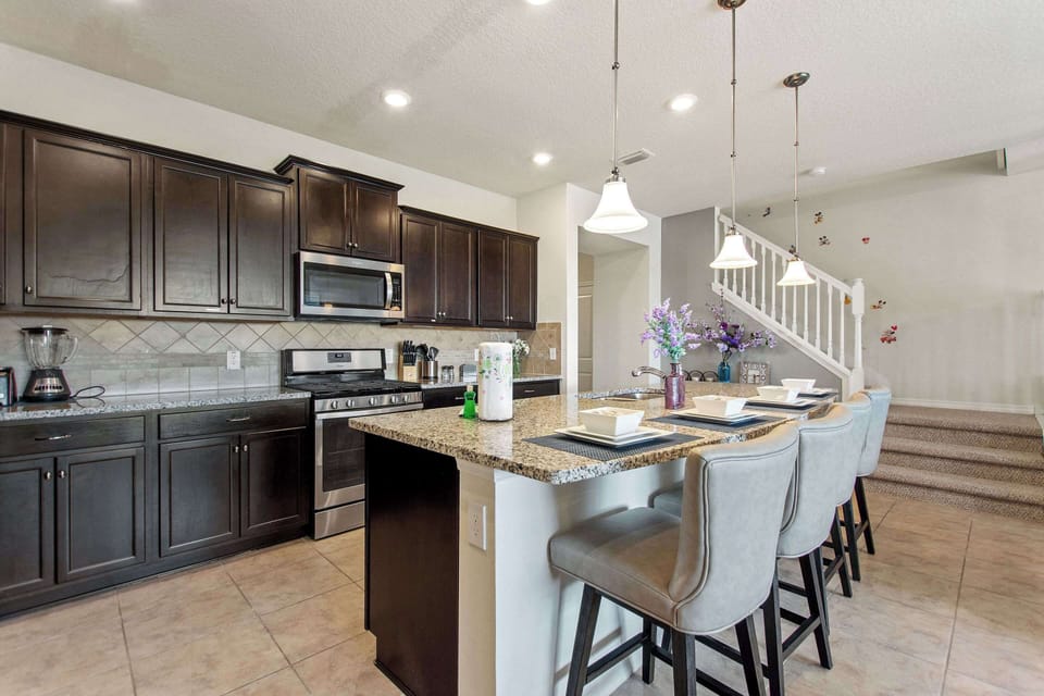 Cook with ease in a sleek kitchen featuring high-quality appliances and plenty of counter space.