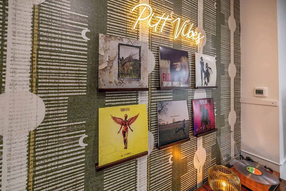 Wall art meets vinyl at Pitt Vibes. Featuring albums like Led Zeppelin IV, Red by Taylor Swift, Fleetwood Mac – Rumours, In Utero by Nirvana. A perfect backdrop to relax or play a record.