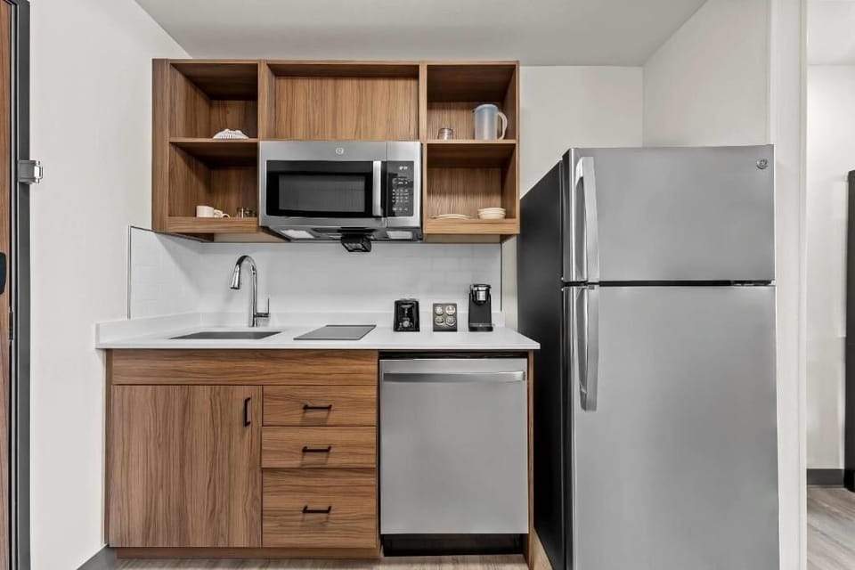 Cook and snack anytime with a sleek kitchenette setup.