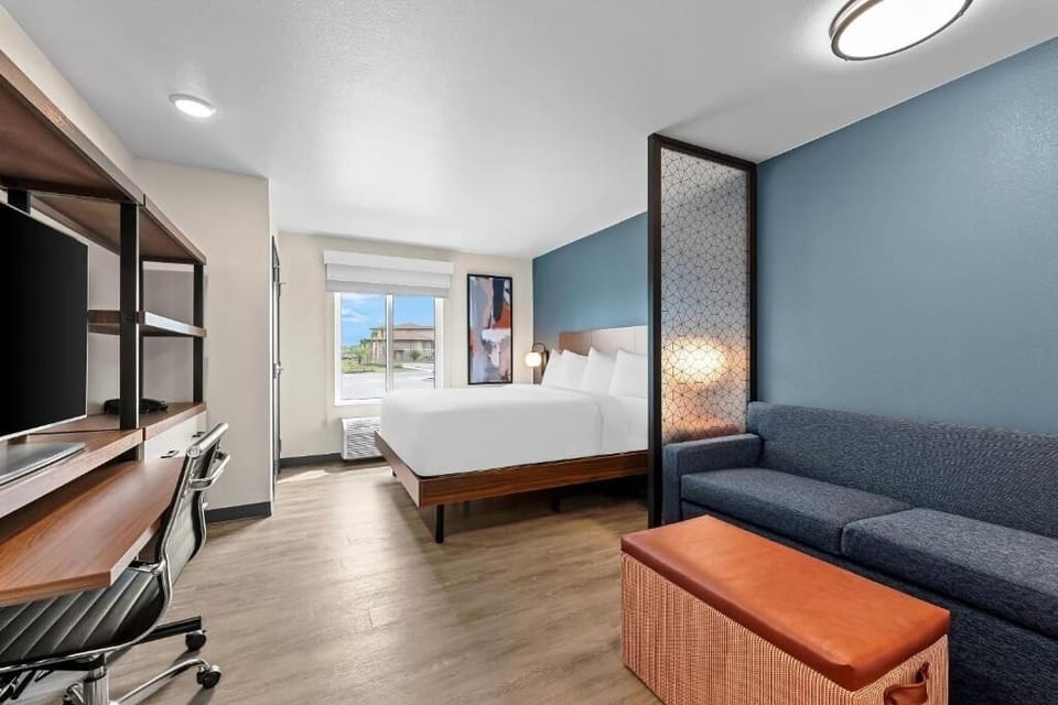 Stretch out with a bright workspace and cozy sleeping area.