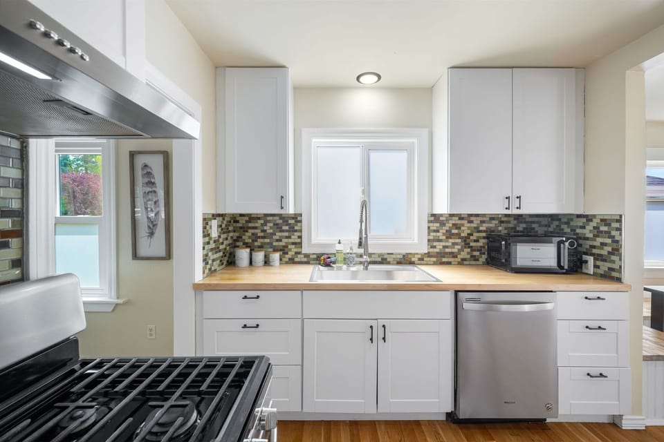 Sleek, fully equipped kitchen with stainless appliances.