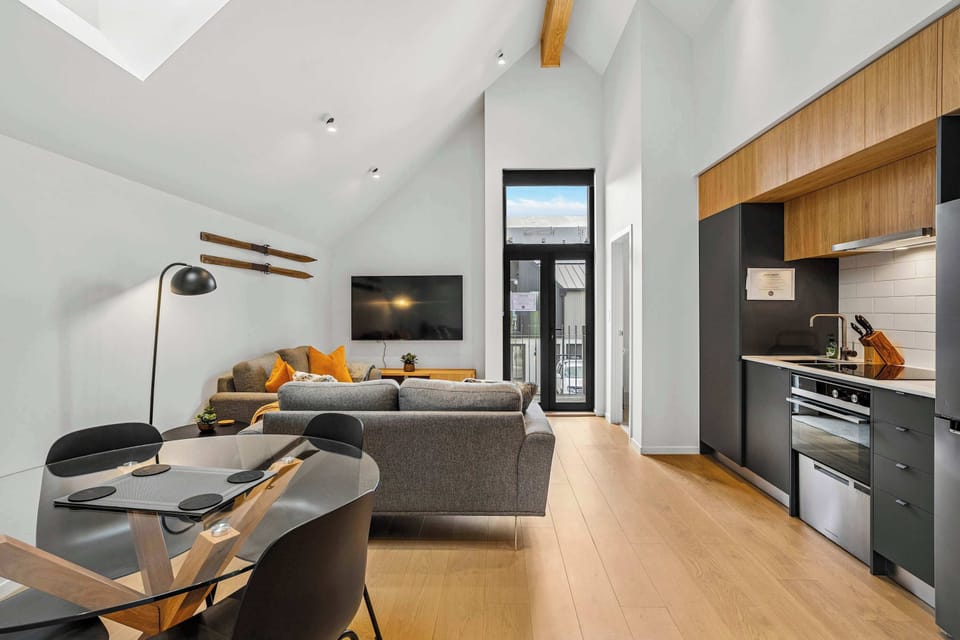Sleek kitchen and lounge with mountain-facing balcony