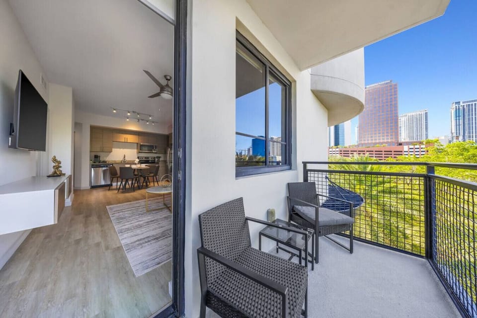 Balcony with Relaxing Seating- Comfortable balcony with chairs and table, perfect for enjoying fresh air, morning coffee, or evening city views right from your stay.
