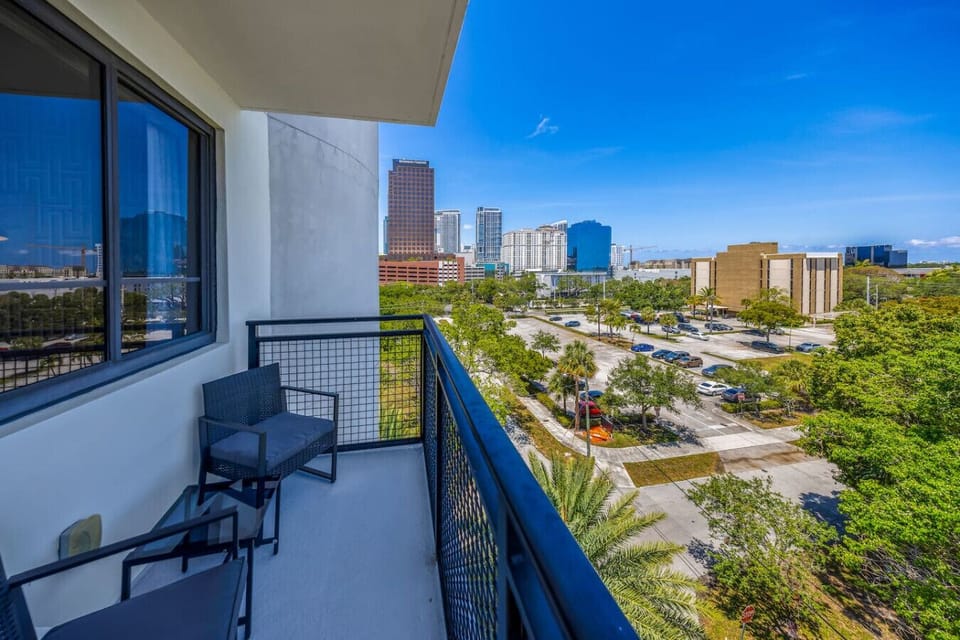 Private Balcony with City Views-Outdoor seating area overlooking the skyline and lush greenery. A perfect spot to relax, sip coffee, or enjoy the fresh air with a beautiful urban backdrop.