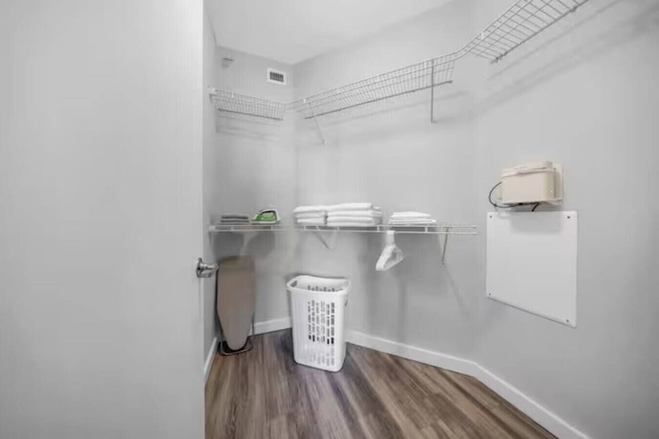 Spacious Walk-In Closet-Large walk-in closet with wire shelving, fresh linens, hangers, and laundry essentials. Perfect for keeping belongings organized during your stay.