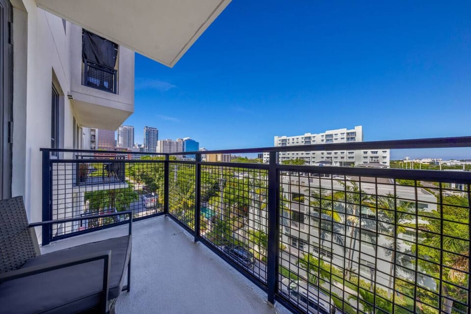 Private Balcony with City Views-Relax on your private balcony with seating, overlooking the courtyard and pool below. Enjoy fresh air and a glimpse of Fort Lauderdale’s skyline.