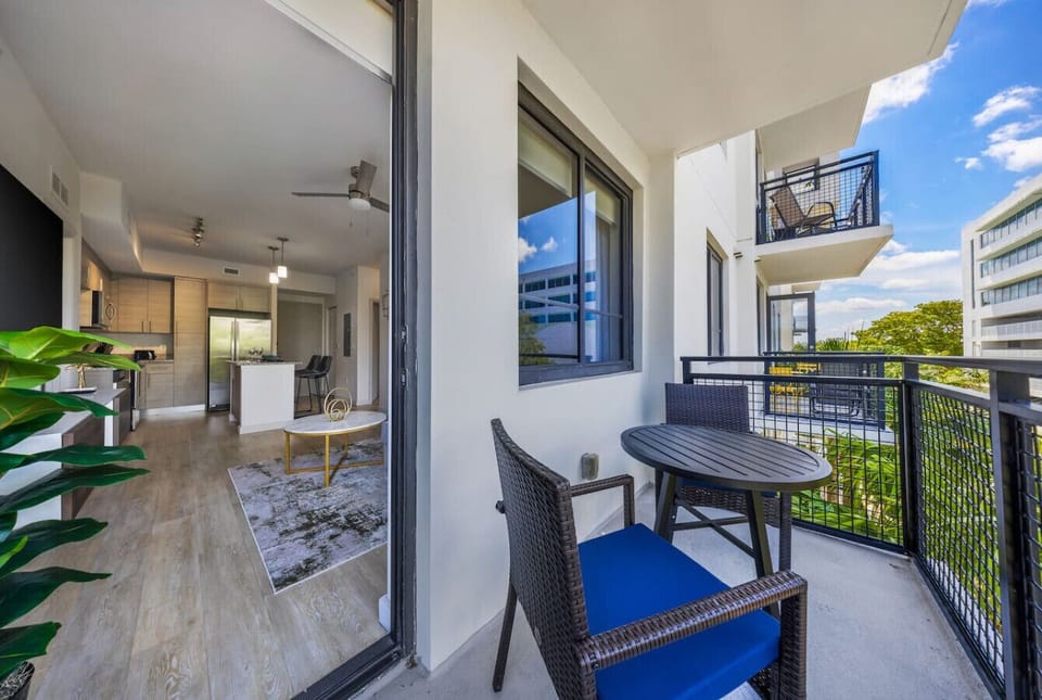 Private Balcony with Seating-Cozy balcony with outdoor chairs and table, perfect for morning coffee or evening relaxation. Enjoy open-air views with easy access to the bright living space inside.