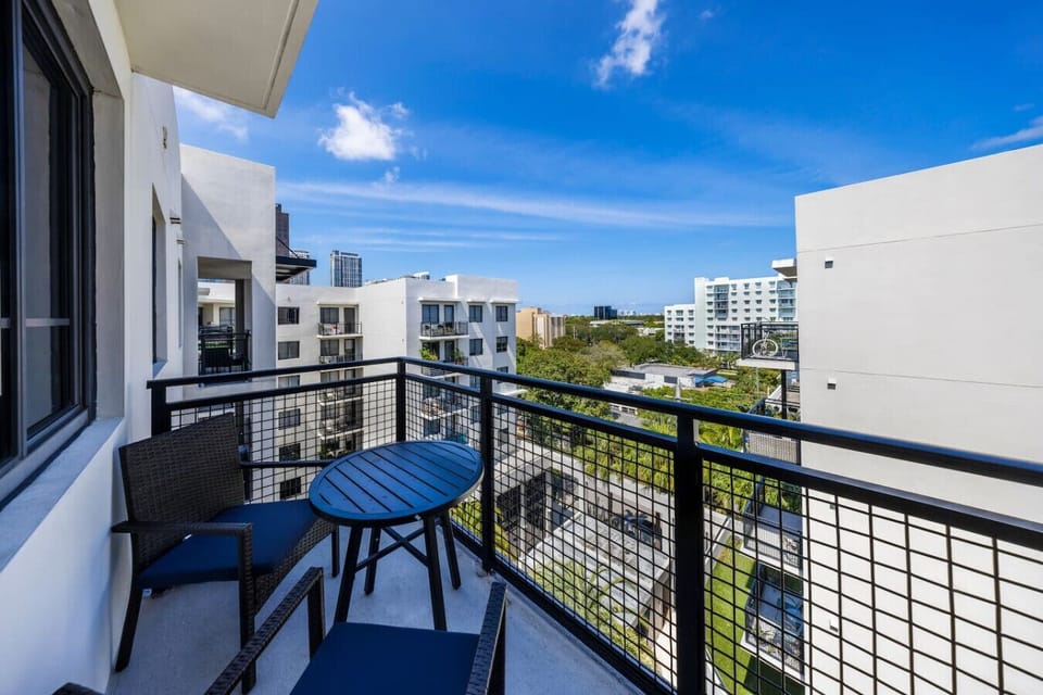 Private Balcony with City Views- Charming balcony with outdoor seating, perfect for enjoying fresh air, city views, and relaxing moments under the open sky.