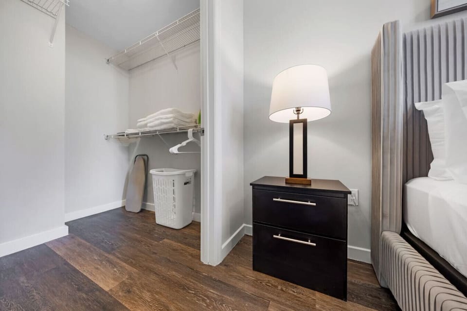 Spacious Walk-In Closet-Convenient walk-in closet with shelving, fresh linens, hangers, ironing board, and laundry basket—perfect for keeping belongings organized during your stay.