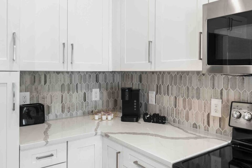 Coffee Station-Convenient coffee setup with Keurig machine, mugs, and pods ready to enjoy. A perfect spot to start your morning or unwind with a warm cup during your stay.