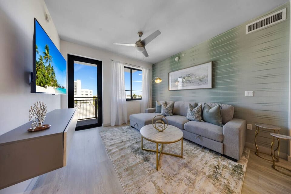 Bright Stylish Living Room-Elegant space with modern décor, cozy sofa, and natural light. Features chic artwork, marble coffee table, and access to a private balcony—perfect for relaxing or entertaining.