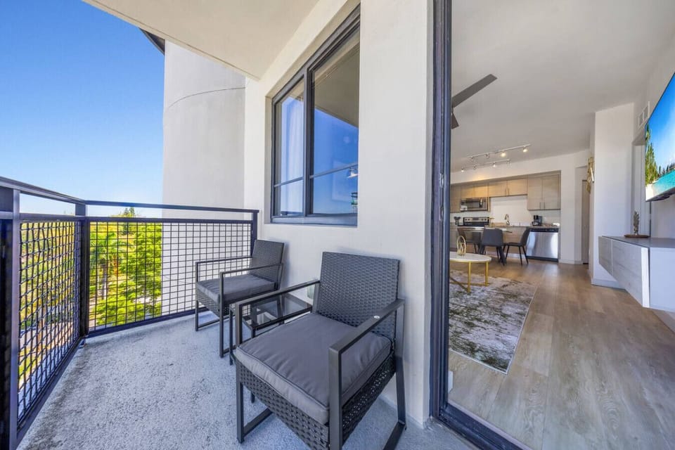 Private Balcony with City Views- Charming balcony with outdoor seating, perfect for enjoying fresh air, city views, and relaxing moments under the open sky.