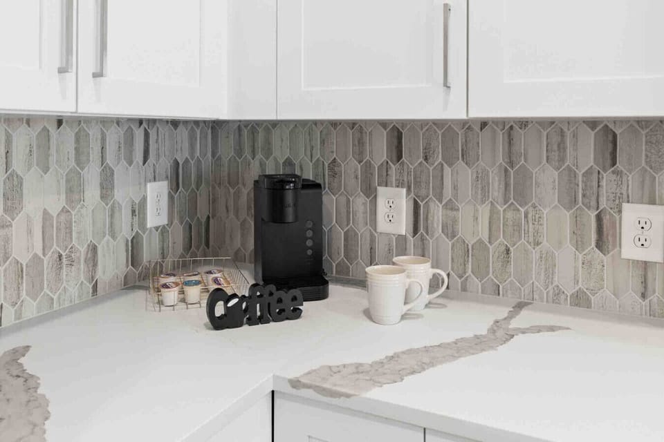 Coffee Station-Convenient coffee setup with Keurig machine, mugs, and pods ready to enjoy. A perfect spot to start your morning or unwind with a warm cup during your stay.