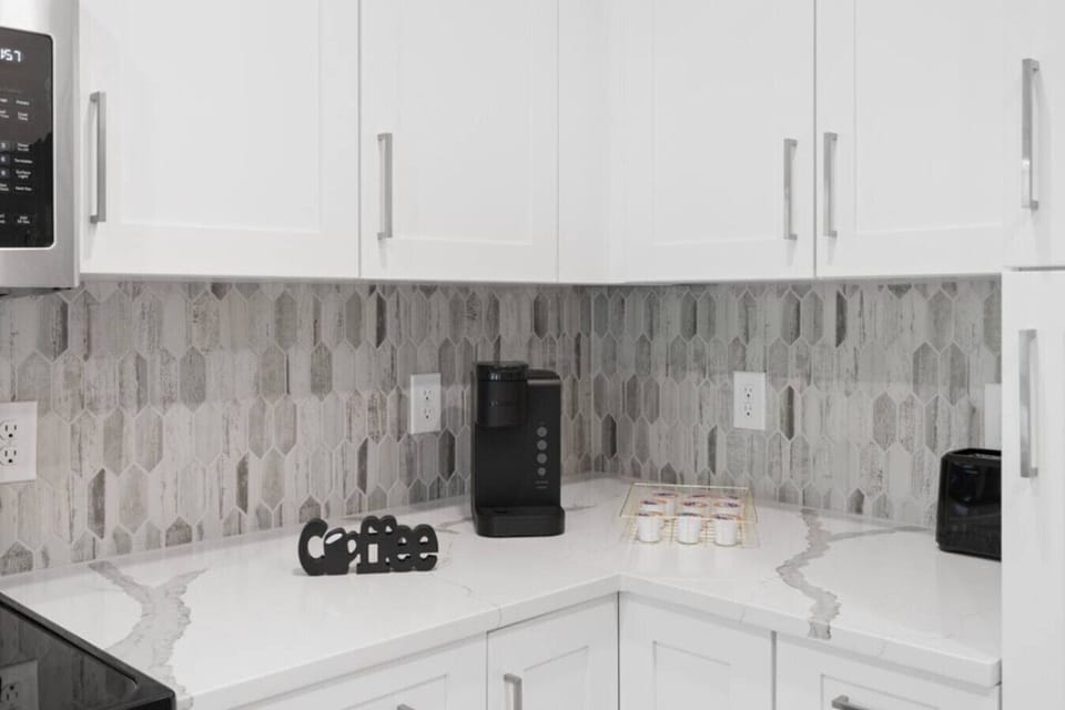 Coffee Station-Convenient coffee setup with Keurig machine, mugs, and pods ready to enjoy. A perfect spot to start your morning or unwind with a warm cup during your stay.