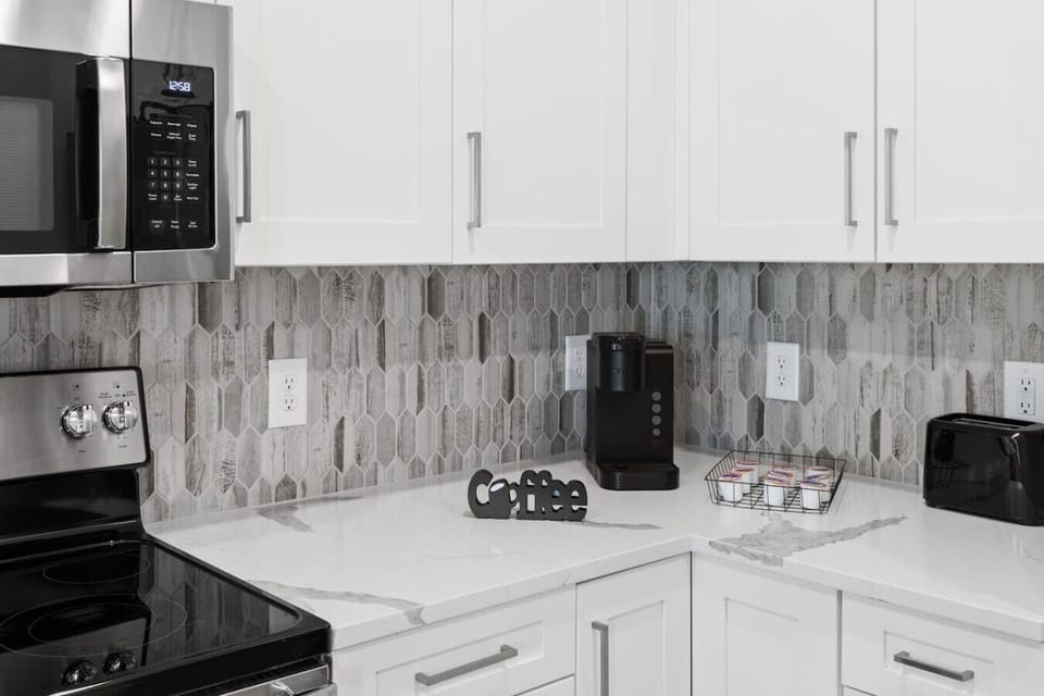 Coffee Corner-Modern kitchen nook with sleek backsplash, coffee maker, and essentials for a perfect morning brew. Bright and functional space to start your day with comfort and style.
